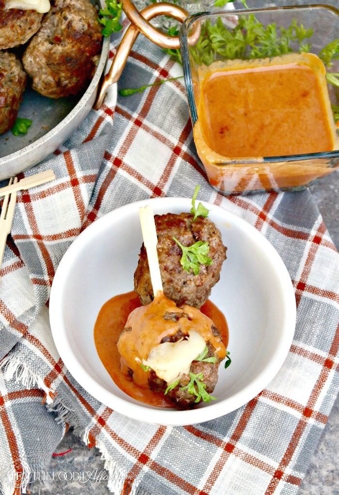 Cheese Stuffed Meatballs with a Creamy Tomato Sauce! Enjoy as an appetizer or serve with pasta #meatballs #cheese #Italian #LCHF | www.thefoodieaffair.com