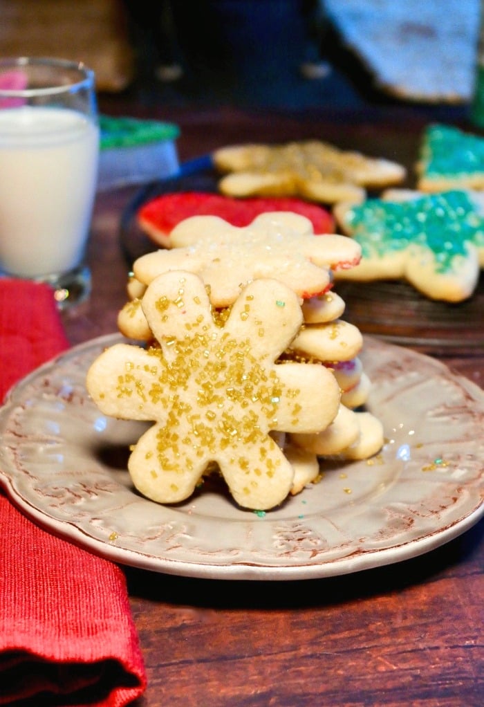 Snow flake cut out cookies on a tan plate