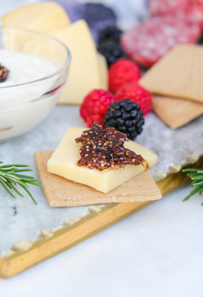 Cheese and crackers with chutney on a marble board. 